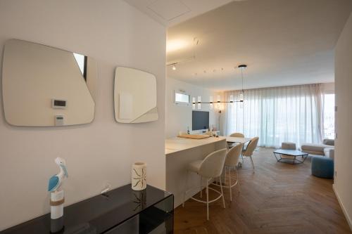 a living room with a kitchen and a dining room at Marina di Scarlino Follonica Vista Mare in Puntone di Scarlino