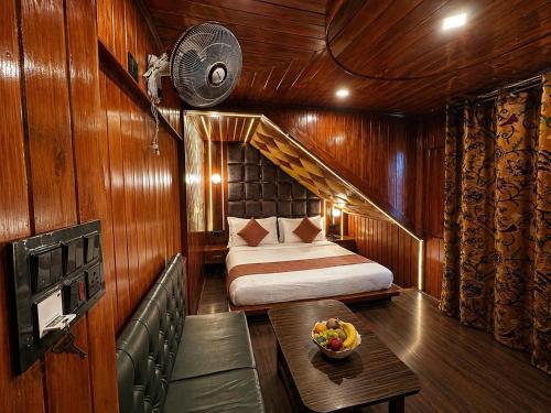 a small room with a bed and a table in it at Pine view in Gulmarg