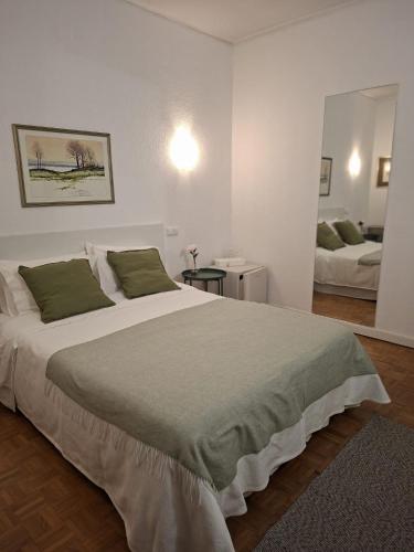 a bedroom with a large bed and a mirror at Porta 80 House in Braga