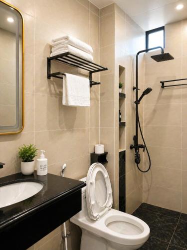 a bathroom with a toilet and a sink and a shower at Sunrise Airport Hotel Noi Bai in Noi Bai