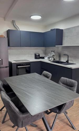 a kitchen with a table and chairs in it at apartment R in Mrljane