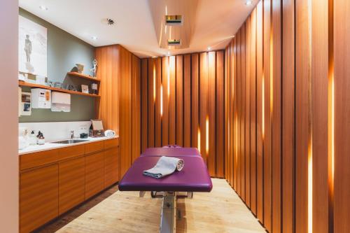 a purple stool in a bathroom with a sink at Mats Lech Alpenquartier in Lech am Arlberg