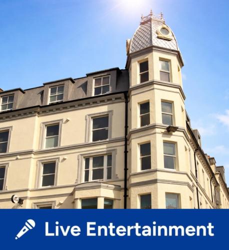 a building with a clock tower on top of it at The New Alexandra Hotel in Llandudno