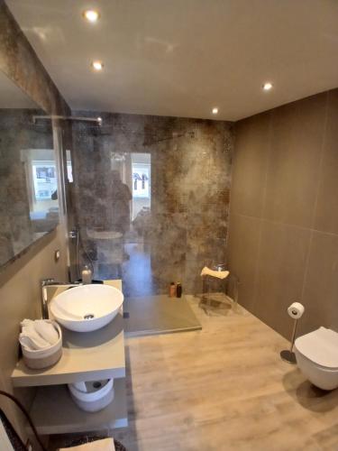 a bathroom with two sinks and two toilets at Central luxury rooms in Olbia
