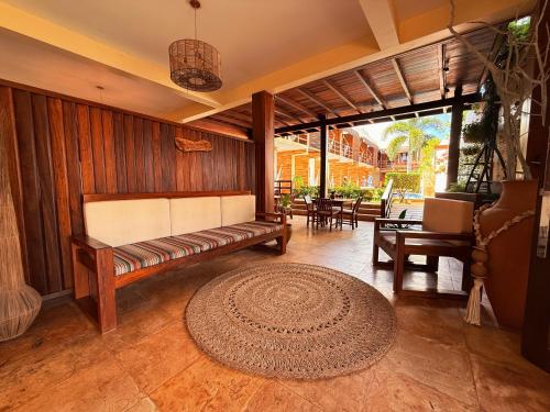 a living room with a couch and a rug at Pousada Jeri Dunas in Jericoacoara