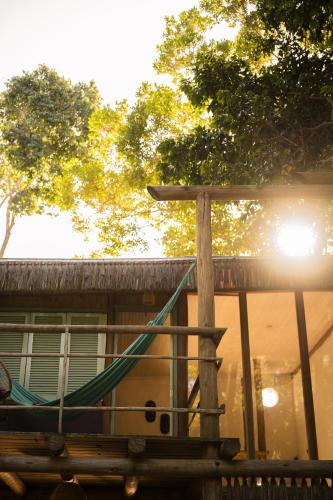 a hammock on the deck of a house at Villa Bakari in Arraial d'Ajuda