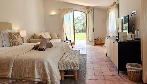 a bedroom with a bed and a television in it at Es Mayolet in Manacor