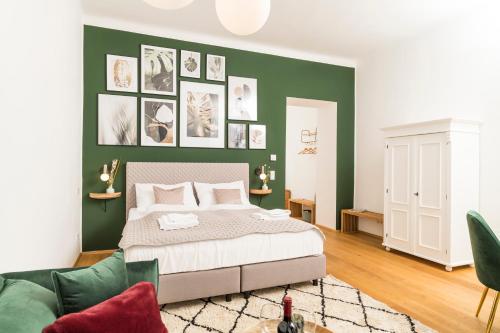 a bedroom with a bed and a green wall at MINTNaschmarkt in Vienna