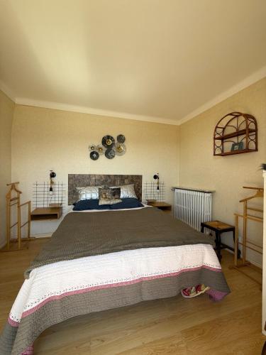 a bedroom with a large bed with clocks on the wall at T3 hypercenter with fireplace, mountain view in Font-Romeu