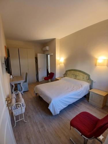 a bedroom with a bed and a table and chairs at Central luxury rooms in Olbia