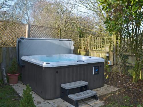 a large hot tub in a yard with a fence at Judd in Launceston