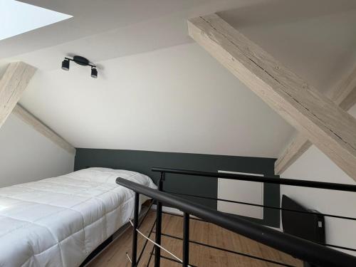 a bedroom with a white bed and a black railing at Duplex moderne hyper-centre Tout à pied in Thonon-les-Bains
