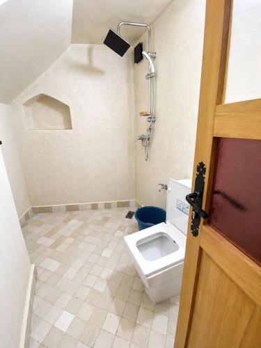 a bathroom with a toilet and a shower at Mirage House in Mirleft