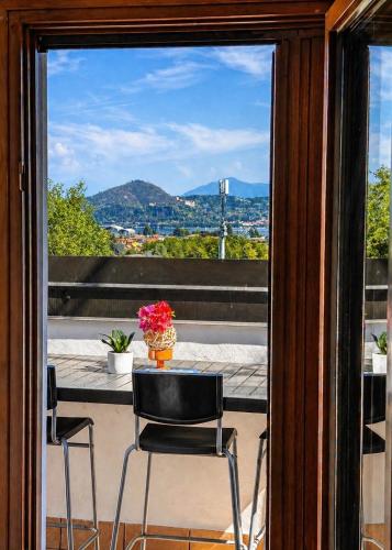 a balcony with two chairs and a table at Villa Motti Quadri in Arona