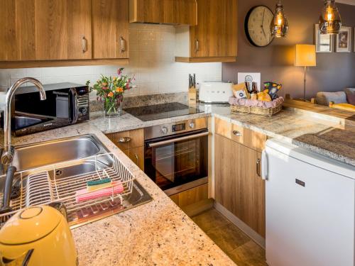 a kitchen with a sink and a counter top at The Helmsley Retreat in Helmsley