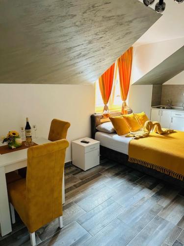 a bedroom with two beds and a table and a desk at Apartmani Romansa in Irig