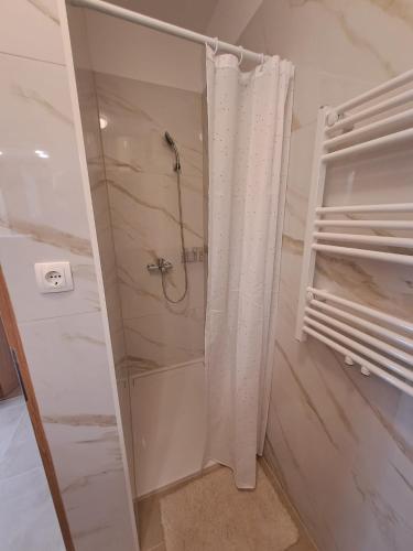 a shower with a shower curtain in a bathroom at Apartment Kazela in Split
