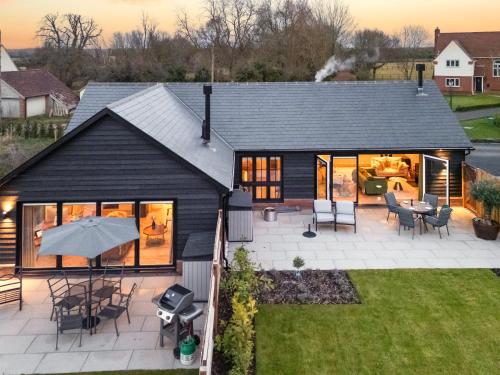 an aerial view of a house with a patio at Uk47692 - Wiggles Cottage in Wimbish