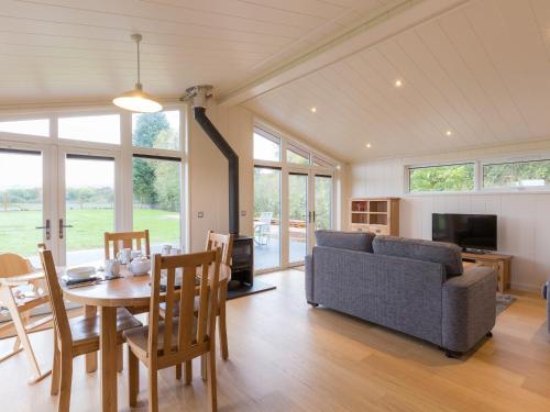 a living room with a table and a couch at Maple Lodge in Hassocks