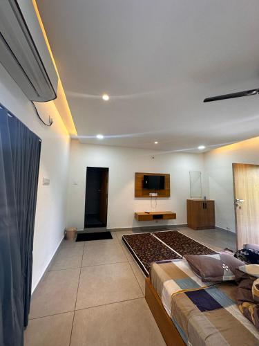 a bedroom with two beds and a flat screen tv at Chandan resort in Chitrāwal