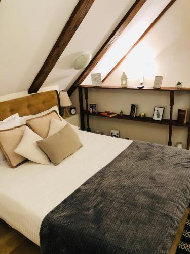 a bedroom with a bed with pillows and a window at Baritiu Apartment Brasov in Braşov