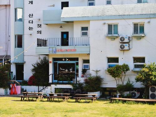 a building with tables in front of it at Suncheon Guest House Nreem in Suncheon