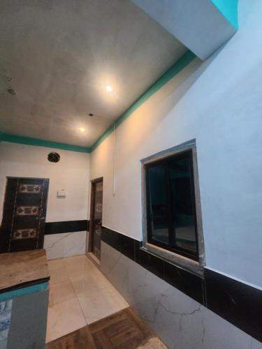 an empty room with a wall with a window at Hotel Neelkamal Guest House in Rewa