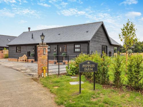 a house with a sign in front of it at Uk47693 - Piglet Cottage in Wimbish