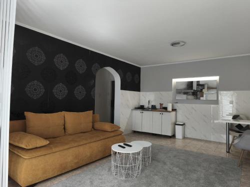 a living room with a couch and a table at Silver Spa Apartment in Bačka Palanka