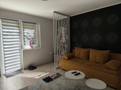 a living room with a couch and a table at Silver Spa Apartment in Bačka Palanka