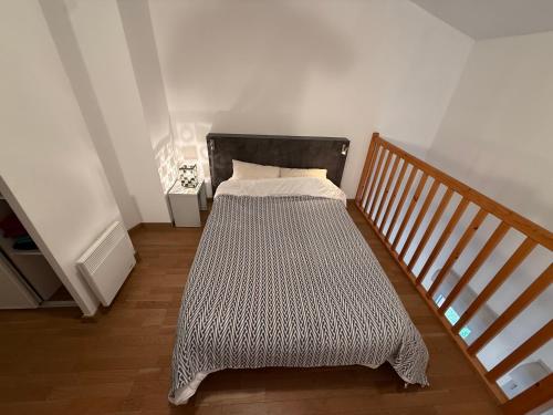 a bed in a room next to a staircase at Duplex Kedge Talence in Talence