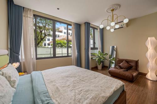 a bedroom with a bed and a large window at Doris Entire House Da Nang in Danang