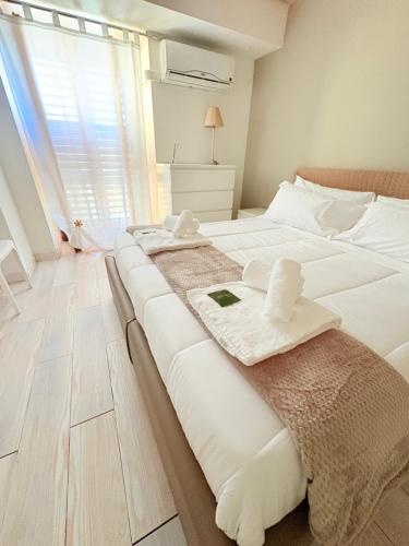 a bedroom with two beds with towels on them at M&S Home in Agrigento