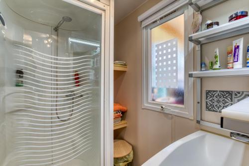 a bathroom with a shower and a sink at Location Mobilhome Agde in Agde