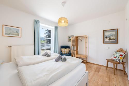 a bedroom with two white beds and a window at Alpine Zeitgeist Apartment - by myNests in Gröbming
