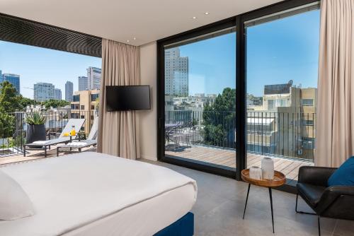 a hotel room with a bed and a large window at master Shenkin in Tel Aviv