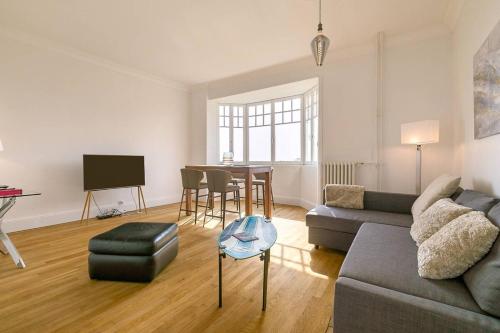 a living room with a couch and a table at Le Victor Hugo in Dijon