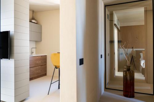a room with a door leading into a kitchen with a table at Infinito Luxury by BarbarHouse in Monopoli