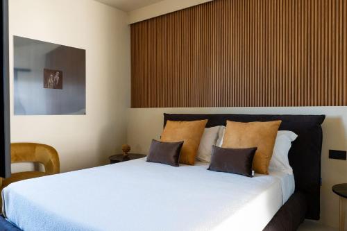 a bedroom with a large white bed with pillows at Infinito Luxury by BarbarHouse in Monopoli