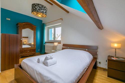 a bedroom with a large bed and a mirror at La Montrachet in Dijon