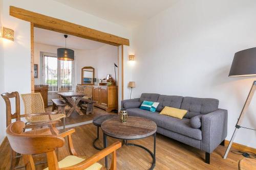 a living room with a couch and a table at La Montrachet in Dijon