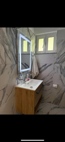 a bathroom with a sink and a mirror at Samuel's Rooms in Theth