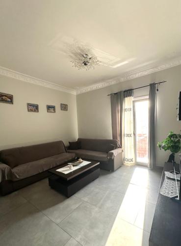 a living room with a couch and a coffee table at Arientas Apartment in Ermoupoli