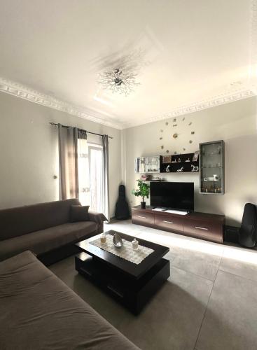 a living room with a couch and a coffee table at Arientas Apartment in Ermoupoli