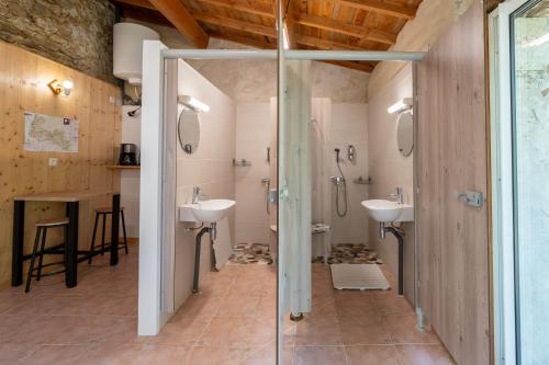 a bathroom with two sinks and a shower at La Roulotte Authentique in Grignan