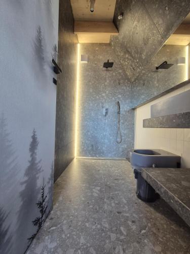 a bathroom with a shower and a blue toilet at Silva Peak House in Zawoja