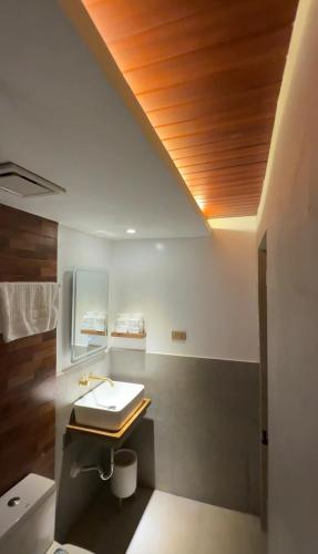 a bathroom with a sink and a toilet at Choox Villa Hotel in Koronadal