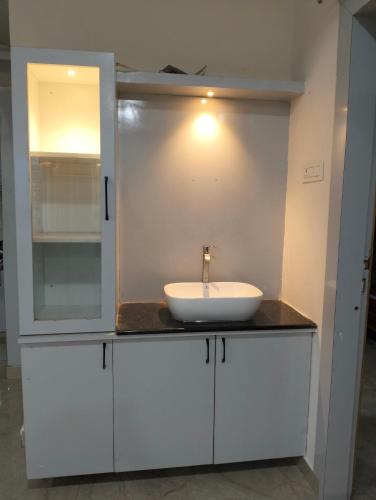 a bathroom with a sink on a counter at Mahadev grand in Tirupati