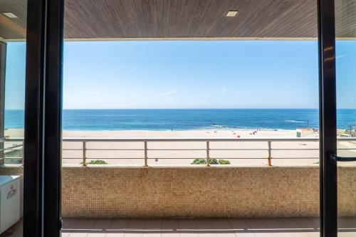 a view of the beach from the balcony of a beach house at Beachouse Pvz - Seafront By Pomerania in Póvoa de Varzim