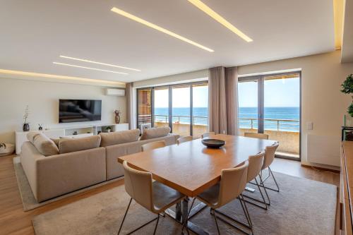 a living room with a table and a couch at Beachouse Pvz - Seafront By Pomerania in Póvoa de Varzim